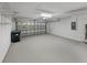 Spacious garage with a clean, painted floor, shelving, and an insulated garage door at 5231 Alavista Dr, Orlando, FL 32837