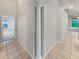 Hallway features a decorative column and tile flooring at 5231 Alavista Dr, Orlando, FL 32837