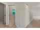 A carpeted hallway leading to a doorway and a closet with a folding door at 5231 Alavista Dr, Orlando, FL 32837