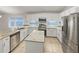 Bright, open kitchen with white cabinetry, granite countertops, stainless steel appliances, and a center island at 5231 Alavista Dr, Orlando, FL 32837