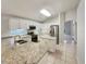 Bright, open kitchen with white cabinetry, granite countertops, stainless steel appliances, and a center island at 5231 Alavista Dr, Orlando, FL 32837