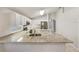 Bright, open kitchen featuring white cabinetry, granite countertops, stainless steel appliances, and a center island at 5231 Alavista Dr, Orlando, FL 32837