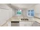Bright kitchen featuring granite countertops, stainless steel appliances and an open view to the living area at 5231 Alavista Dr, Orlando, FL 32837