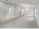 Open living room with carpet, tile flooring, and architectural columns at 5231 Alavista Dr, Orlando, FL 32837