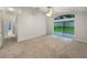 Bright living room with carpet and sliding glass doors that provide access to the back yard at 5231 Alavista Dr, Orlando, FL 32837