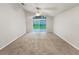 Large living room featuring carpet flooring, a ceiling fan and sliding glass doors to the yard at 5231 Alavista Dr, Orlando, FL 32837