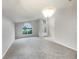 Spacious living room with carpeted floors and large windows offering great natural light at 5231 Alavista Dr, Orlando, FL 32837