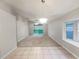 Spacious living room with carpet flooring, a ceiling fan, a bay window and sliding glass doors leading to the backyard at 5231 Alavista Dr, Orlando, FL 32837