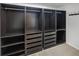 A walk-in closet is shown with dark colored storage drawers and open shelves at 5231 Alavista Dr, Orlando, FL 32837