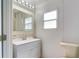 Cozy bathroom featuring a modern sink, a vanity, and ample lighting at 5517 W Sacramento Ct, Orlando, FL 32821