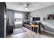 Bedroom with hardwood floors, ceiling fan, and a comfortable seating area at 5517 W Sacramento Ct, Orlando, FL 32821