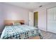 Cozy bedroom with light purple walls, light wood floors, and a comfortable bed with a decorative quilt at 5517 W Sacramento Ct, Orlando, FL 32821