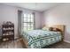 Comfortable bedroom with a window view and a decorative bookshelf, providing ample storage space at 5517 W Sacramento Ct, Orlando, FL 32821