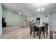 Open-concept dining area with wood flooring, modern lighting, and stylish decor at 5517 W Sacramento Ct, Orlando, FL 32821
