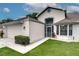 Two-story home features a well-kept lawn, a screened entrance and a two car garage at 5517 W Sacramento Ct, Orlando, FL 32821