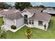 Aerial view of a well-maintained single-story home with manicured lawn and white rock beds at 5517 W Sacramento Ct, Orlando, FL 32821