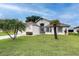 Charming single-story home features a well-manicured lawn and tropical palm trees at 5517 W Sacramento Ct, Orlando, FL 32821