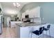 Bright, spacious kitchen with a breakfast bar featuring granite countertops and white cabinetry at 5517 W Sacramento Ct, Orlando, FL 32821
