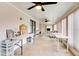 Multi-purpose living room with lots of tables, natural light, and a versatile design for creative pursuits at 5517 W Sacramento Ct, Orlando, FL 32821