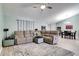 Comfortable living area with plush seating, ceiling fan, and decorative rug at 5517 W Sacramento Ct, Orlando, FL 32821