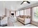 Comfortable living room featuring a neutral sofa, a TV, and lots of natural light at 5517 W Sacramento Ct, Orlando, FL 32821