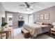 Spacious main bedroom featuring modern decor, a ceiling fan, and a serene atmosphere for relaxation at 5517 W Sacramento Ct, Orlando, FL 32821