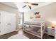 bedroom with bunkbeds, ceiling fan, neutral walls, and light-colored floors at 610 Strihal Loop, Oakland, FL 34787