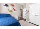 Bright bedroom offers a fun dinosaur theme, ceiling fan, and comfortable sleeping space at 610 Strihal Loop, Oakland, FL 34787