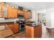 Stylish kitchen featuring modern appliances, granite countertops, and hardwood floors at 610 Strihal Loop, Oakland, FL 34787