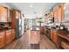 Well-equipped kitchen with stainless steel appliances, ample cabinetry, and a center island at 610 Strihal Loop, Oakland, FL 34787