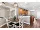 Eat-in kitchen area with a wooden table, chairs, and views into the adjacent kitchen at 610 Strihal Loop, Oakland, FL 34787