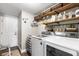 Well-organized laundry room with shelving, washer, and dryer at 610 Strihal Loop, Oakland, FL 34787