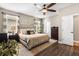 Comfortable main bedroom features warm tones, a ceiling fan, and ample closet space at 610 Strihal Loop, Oakland, FL 34787