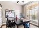 Comfortable home office with a large desk, whiteboard, and natural light at 610 Strihal Loop, Oakland, FL 34787