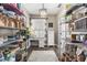 Organized pantry with ample shelving and a built-in desk area at 610 Strihal Loop, Oakland, FL 34787