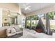 Covered patio featuring comfortable seating, an egg chair, and a view of the backyard at 610 Strihal Loop, Oakland, FL 34787