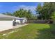 Backyard with patio, outdoor seating area with umbrella, grill, and fenced yard at 63 Madera Rd, Debary, FL 32713