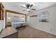 Large main bedroom with wood beam detail, modern ceiling fan and en suite bathroom at 63 Madera Rd, Debary, FL 32713