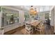 Dining room with wood table, six chairs, natural lighting and a view of the back yard at 63 Madera Rd, Debary, FL 32713
