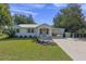 Charming single story home with metal roof, covered entry and carport, and manicured front lawn at 63 Madera Rd, Debary, FL 32713