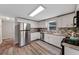 Bright kitchen featuring updated cabinets, stainless appliances, and stylish backsplash at 63 Madera Rd, Debary, FL 32713
