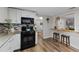 Updated kitchen featuring granite countertops, stainless appliances, and eat-in breakfast bar at 63 Madera Rd, Debary, FL 32713