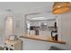 Bright kitchen features white cabinets, stainless appliances, breakfast bar and stylish backsplash at 63 Madera Rd, Debary, FL 32713