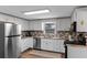 Charming kitchen featuring updated cabinets, stainless appliances, and stylish tile backsplash at 63 Madera Rd, Debary, FL 32713