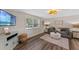 Bright living room with wood-look floors, modern furnishings, and decorative lighting at 63 Madera Rd, Debary, FL 32713