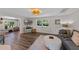 Bright living room featuring luxury vinyl plank flooring, modern furnishings, and a large window at 63 Madera Rd, Debary, FL 32713