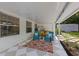 Covered patio seating area with checkerboard floor, bar and view to the backyard at 63 Madera Rd, Debary, FL 32713