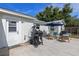 Back patio area featuring a grill and outdoor seating with room for entertaining at 63 Madera Rd, Debary, FL 32713