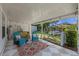 Covered patio featuring lounge seating, bar and landscaped backyard with stepping stones at 63 Madera Rd, Debary, FL 32713