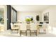 Bright dining room with a long table and chairs. View of living room and view to the outside at 695 Peroni Ave, Debary, FL 32713